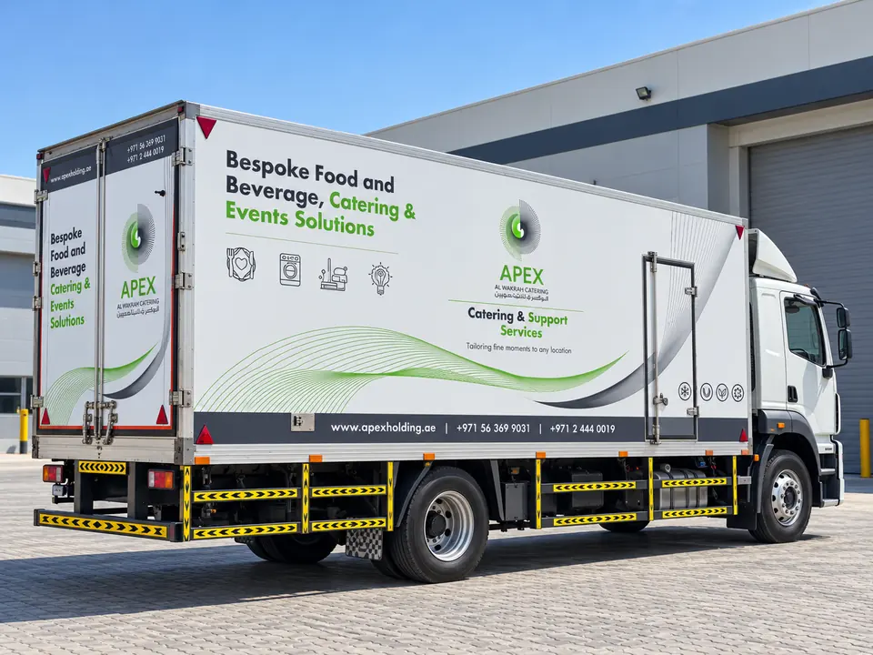 APEX Catering refrigerated truck with full-side vinyl branding, being fitted by the Victory team