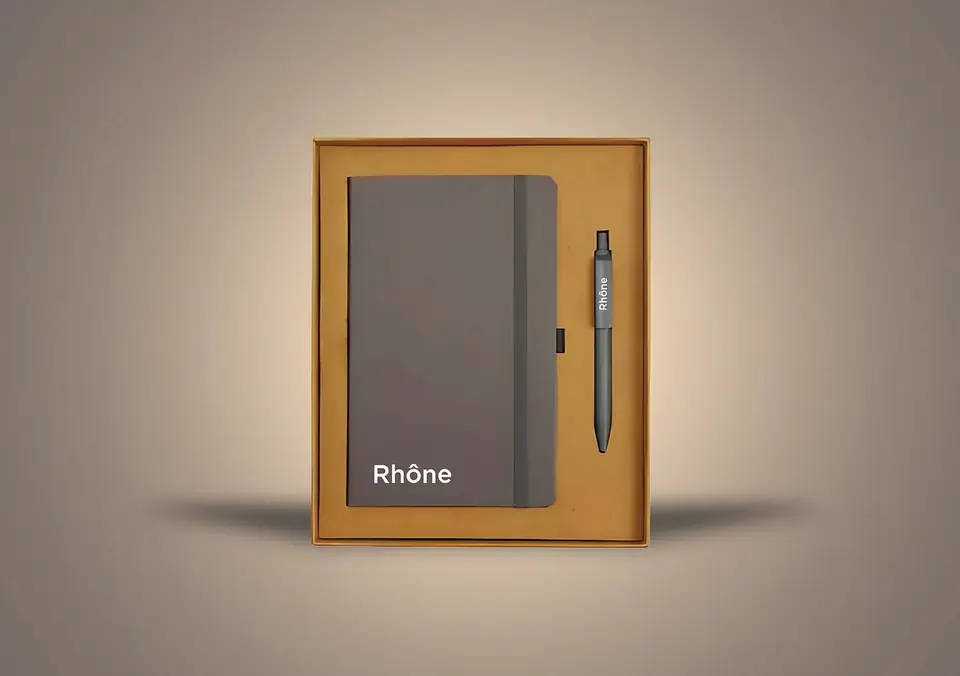 Branded grey notebook and pen in a kraft gift box